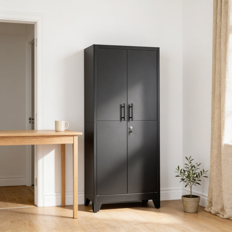 Tall black metal storage cabinet with two lockable doors standing against a bone-white wall in a home office beside a light oak desk.