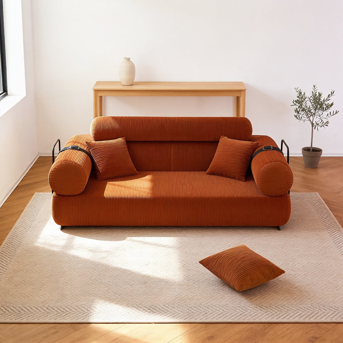 Burnt orange corduroy folding sofa bed in sofa mode, seventy-nine inch size.