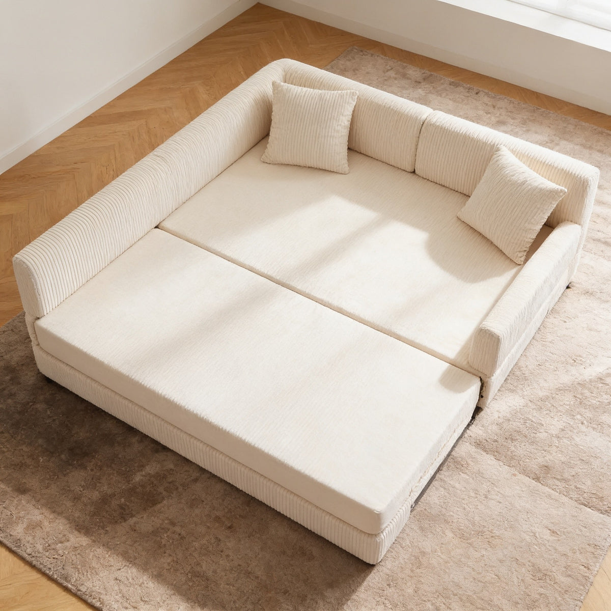 Beige corduroy sofa bed opened flat into bed mode, forming a near-square two hundred by one hundred and eighty centimetre mattress on the rug.