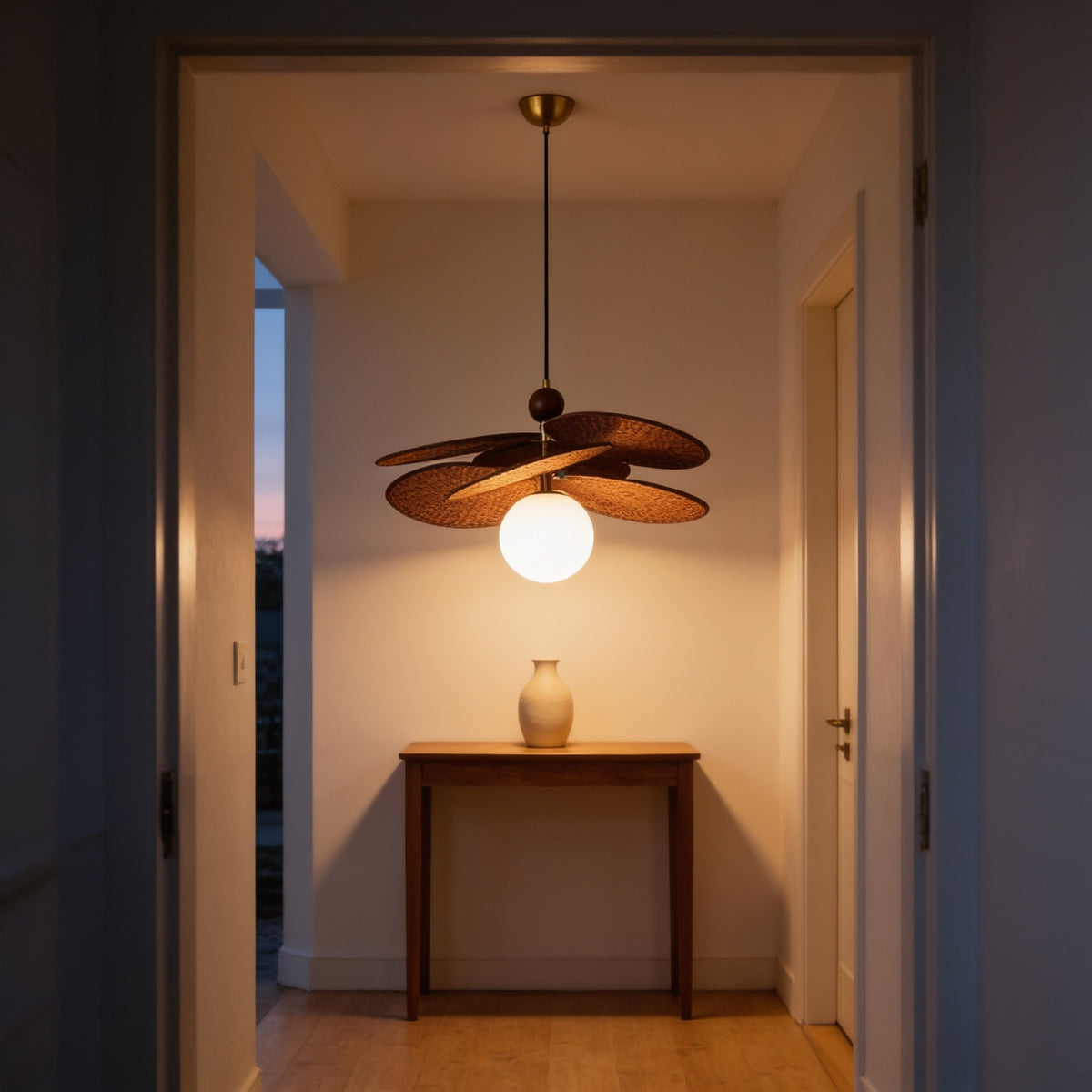 Single-globe woven leaf pendant light hanging in an entrance hallway.