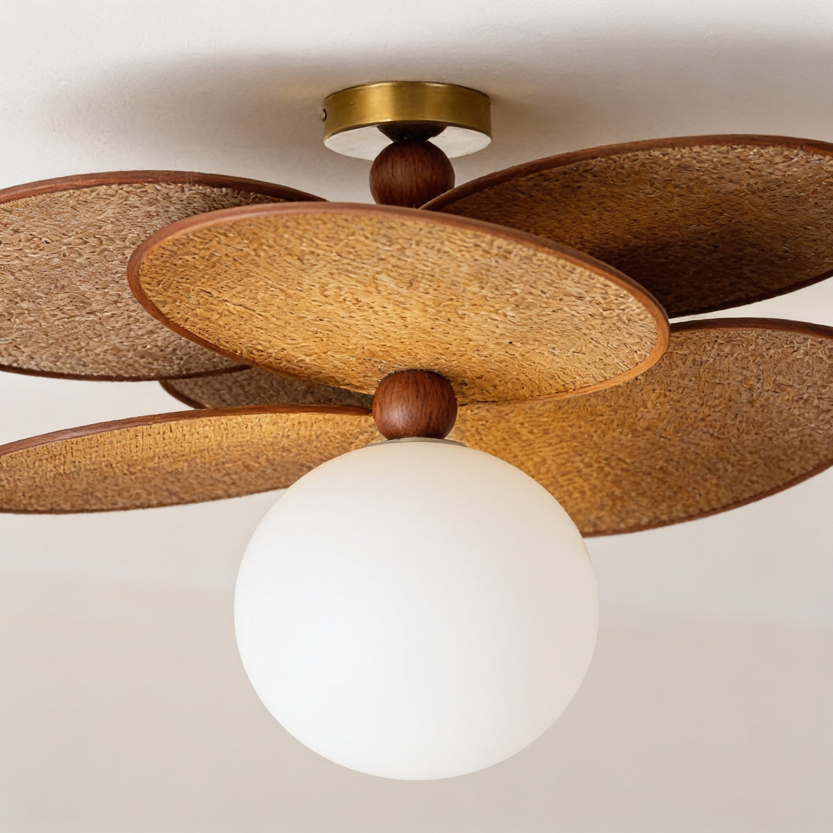 Close detail of the woven leaf panels, walnut bead and brass fittings.