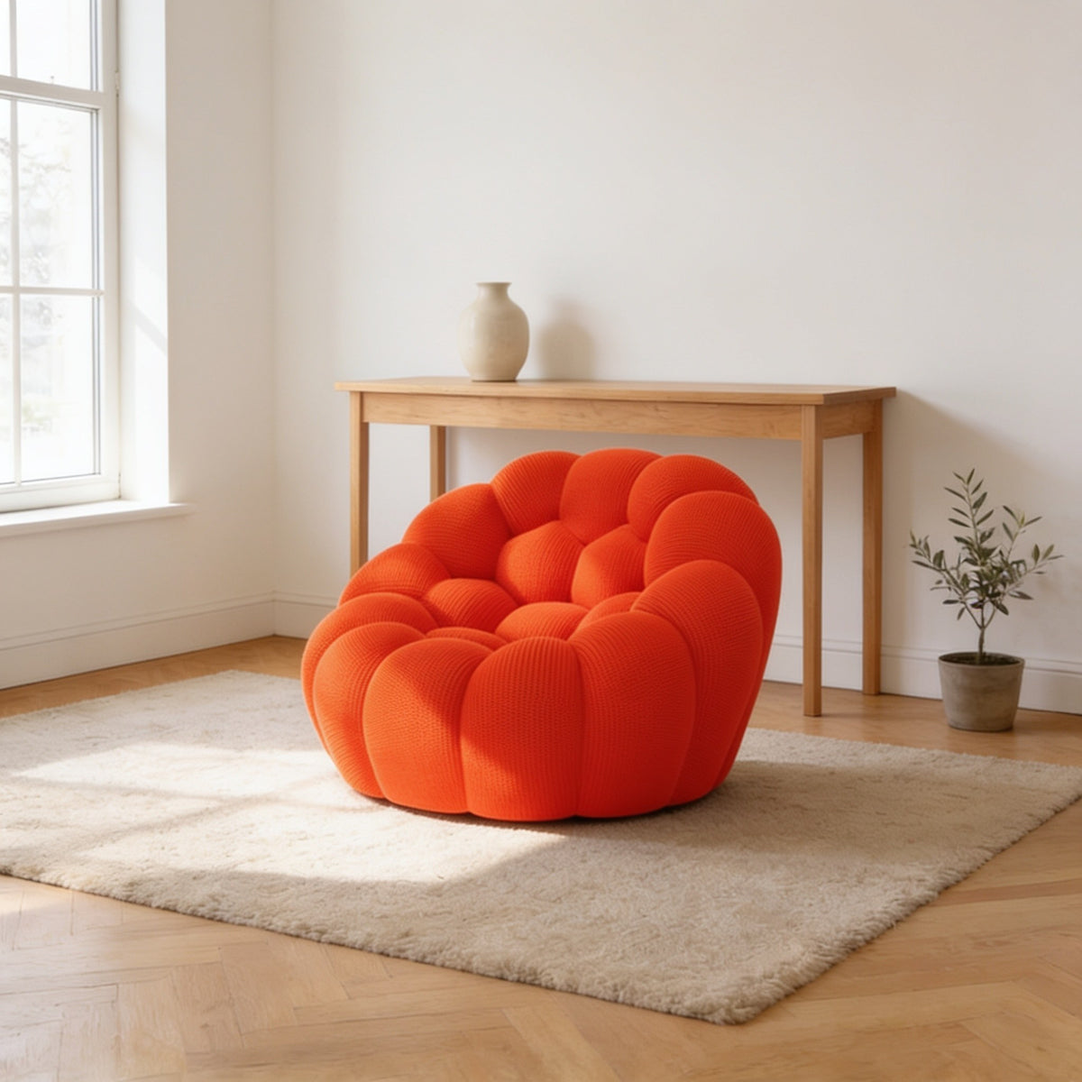 Bright orange bubble armchair in a three-dimensional mesh knit, one hundred and twenty-four centimetres wide.