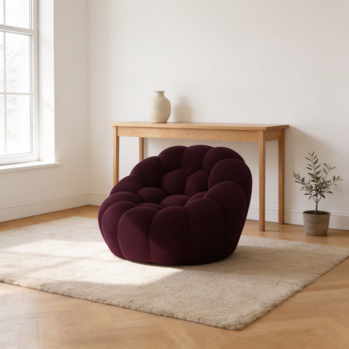Dark purple bubble armchair in a three-dimensional mesh knit, one hundred and twenty-four centimetres wide.