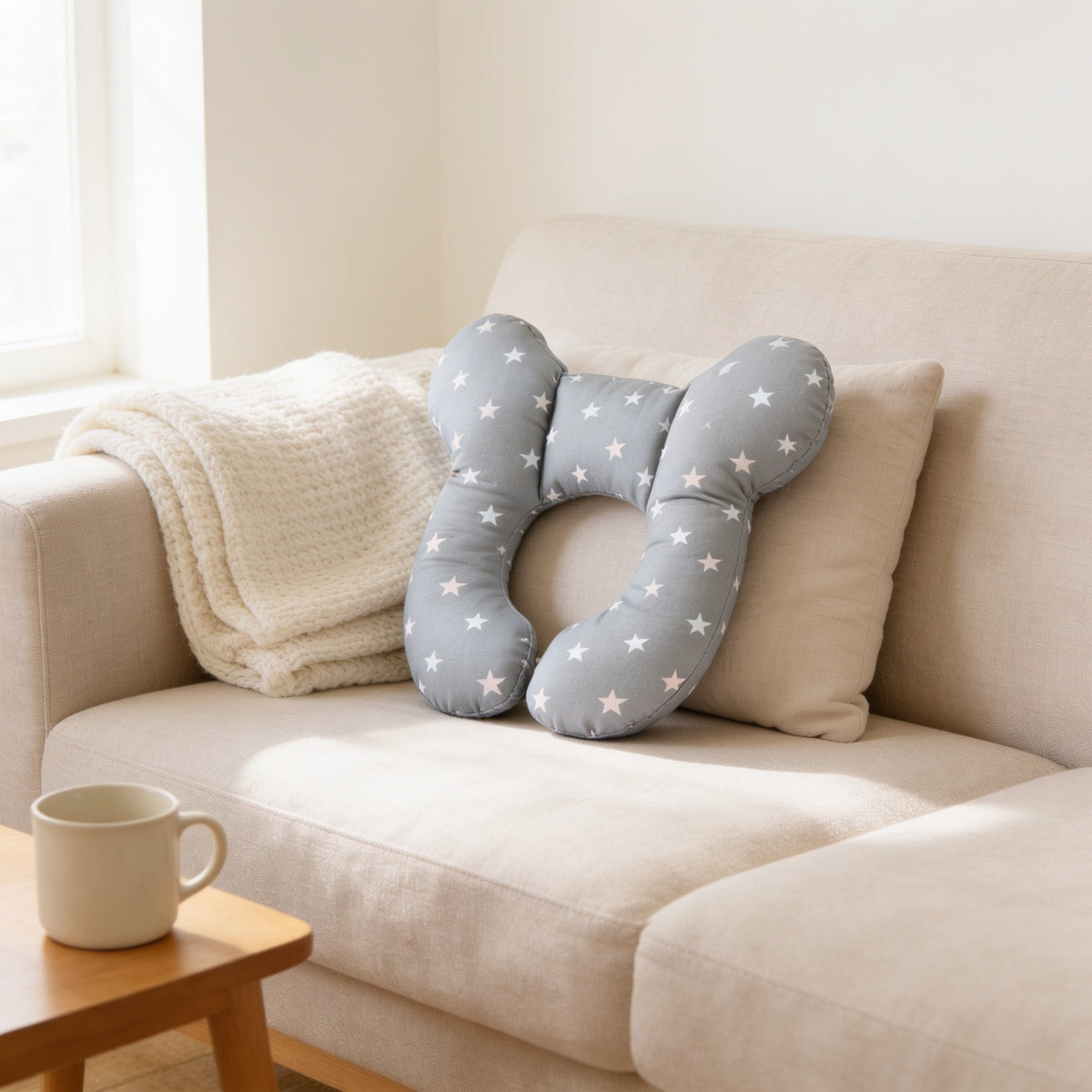 Gray moon and stars print U-shaped toddler neck pillow.