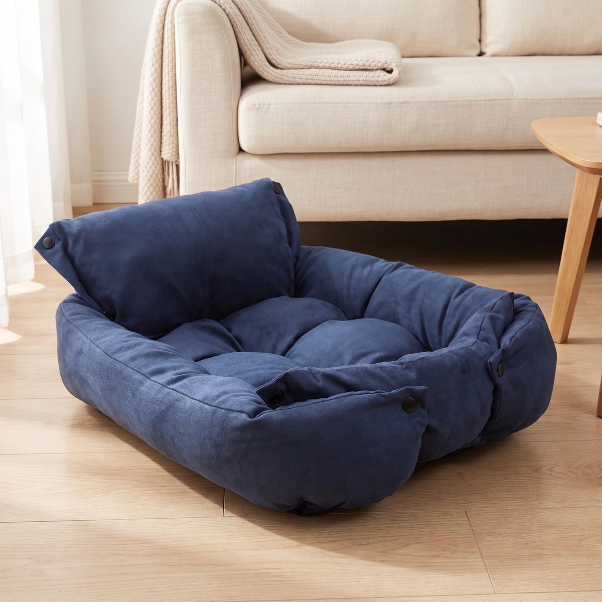 Navy convertible pet bed in its walled shape on a living room floor
