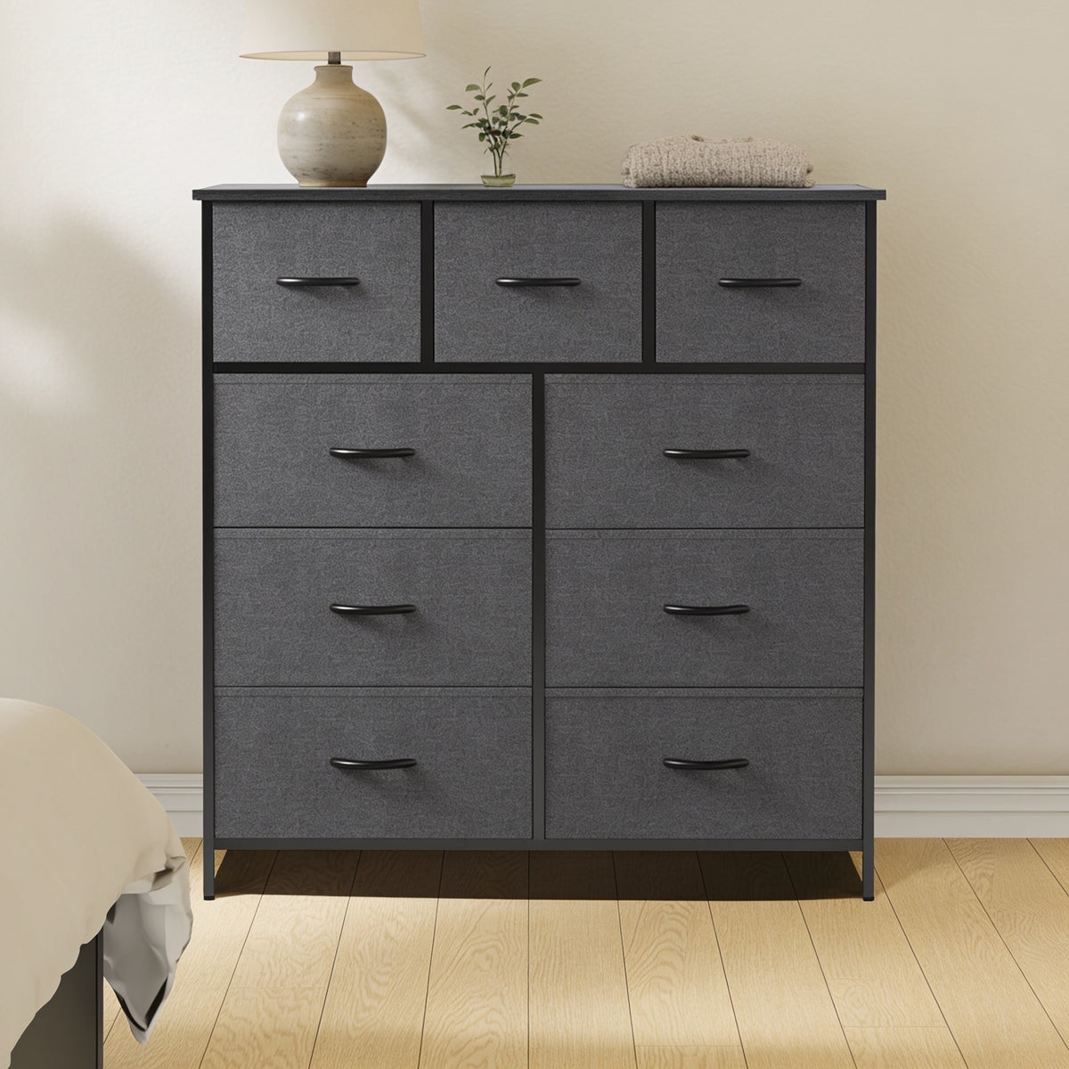 Dark Gray 9-drawer fabric dresser with steel frame in a bedroom.