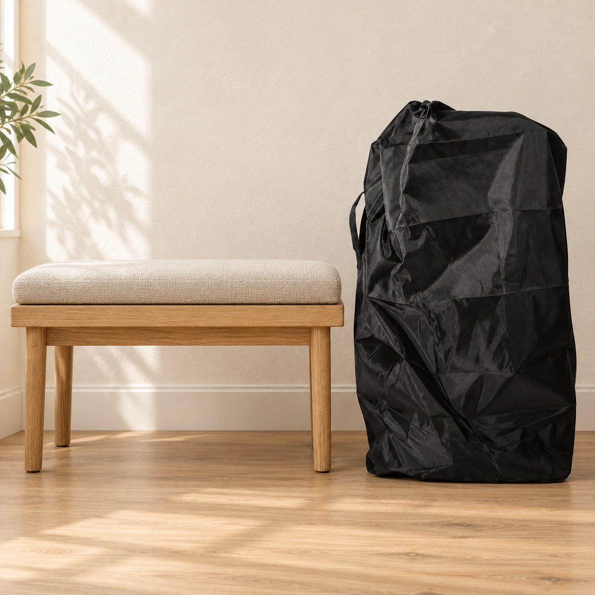 Black middle-size stroller travel cover beside an oak bench showing its height against the seat