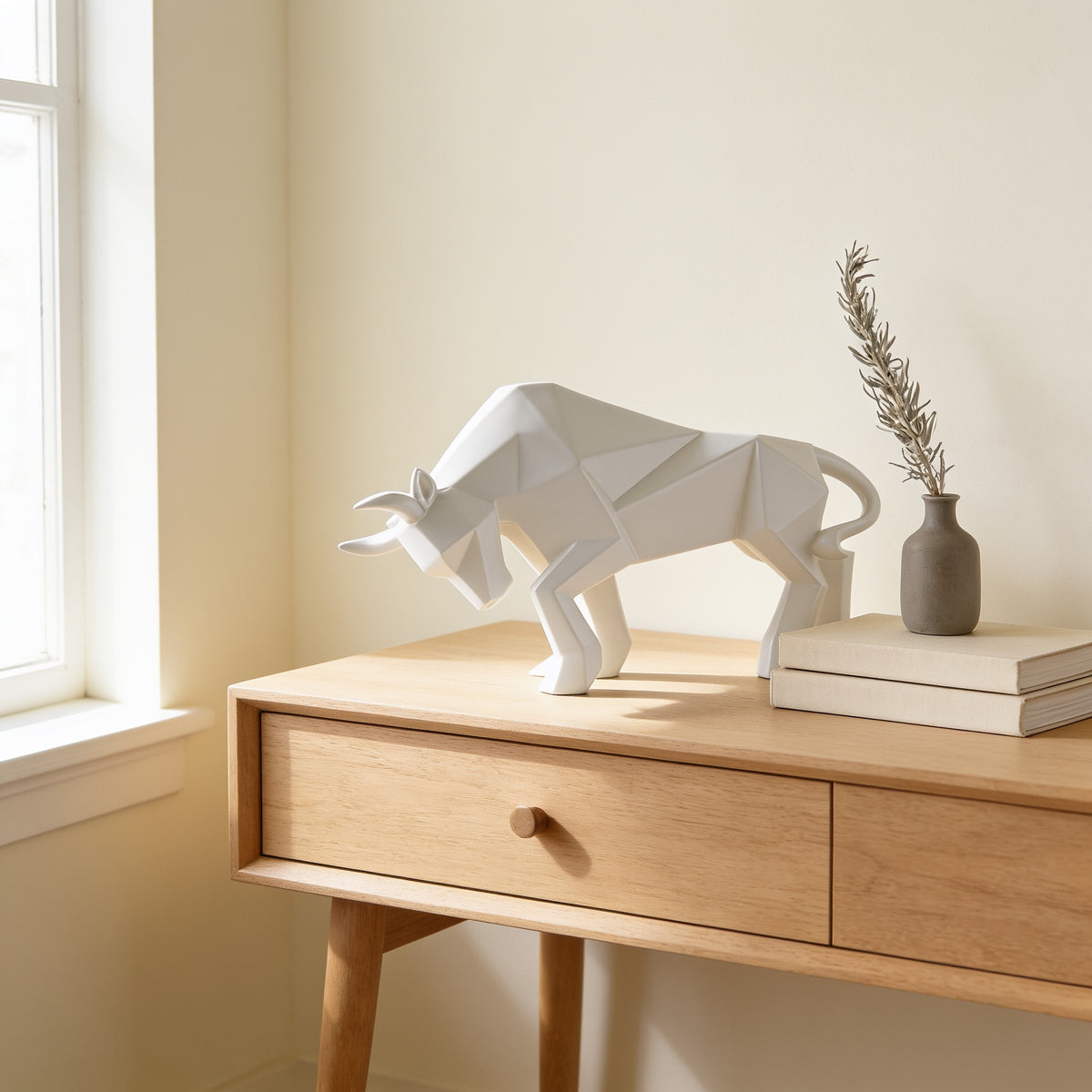 White faceted bull statue, small charging pose, on an oak console — Faceted Geometric Bull Statue