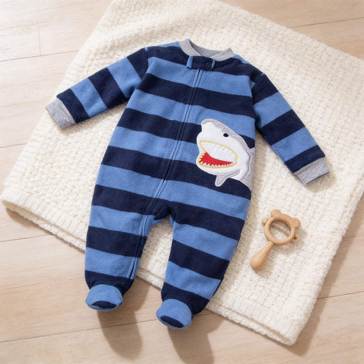 Blue Shark Stripe fleece zip-up footie pajamas with closed feet, laid flat.