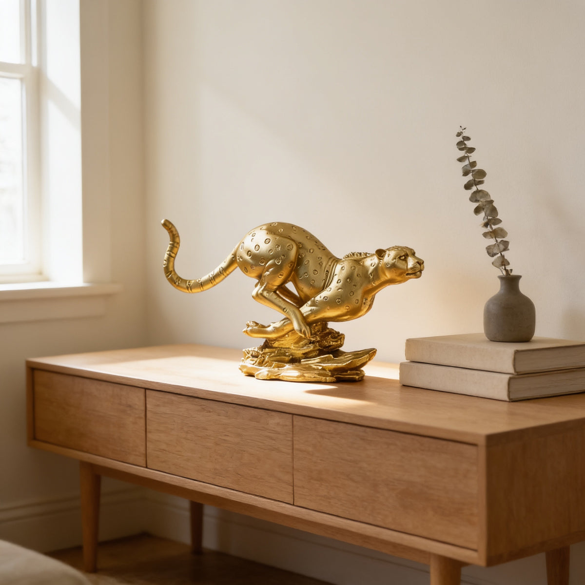 Gold running leopard statue on a sideboard in a sunlit living room