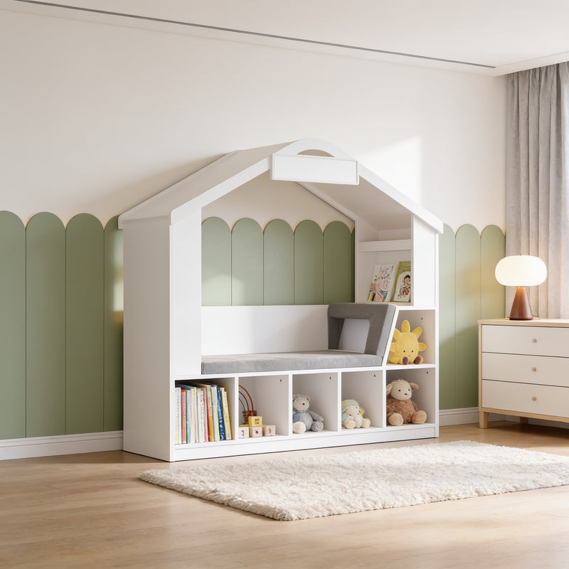 White kids house bookshelf with reading nook against a sage-panelled bedroom wall, gray cushioned bench and five open cubbies, 140 cm tall.