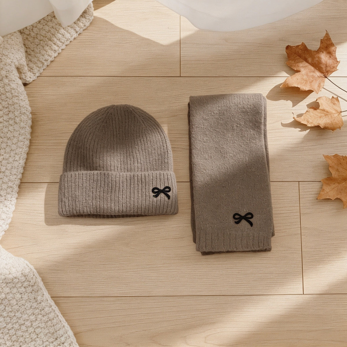 Taupe ribbed knit kids hat and scarf set with embroidered bows.