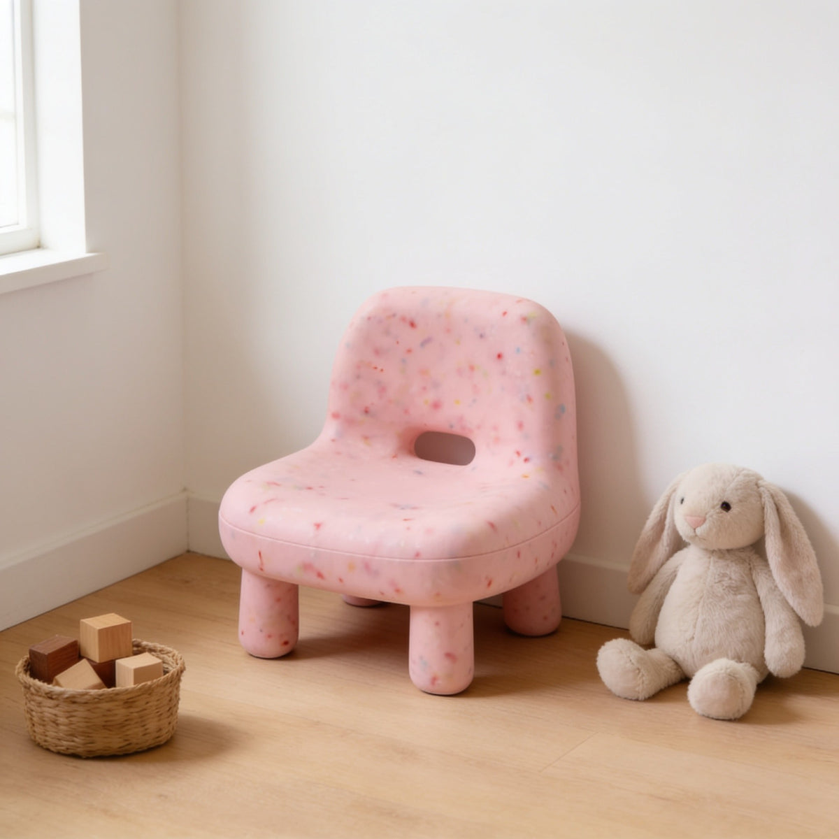 Pink (Low) speckled molded kids chair with a hand-hole backrest in a sunny kids room.