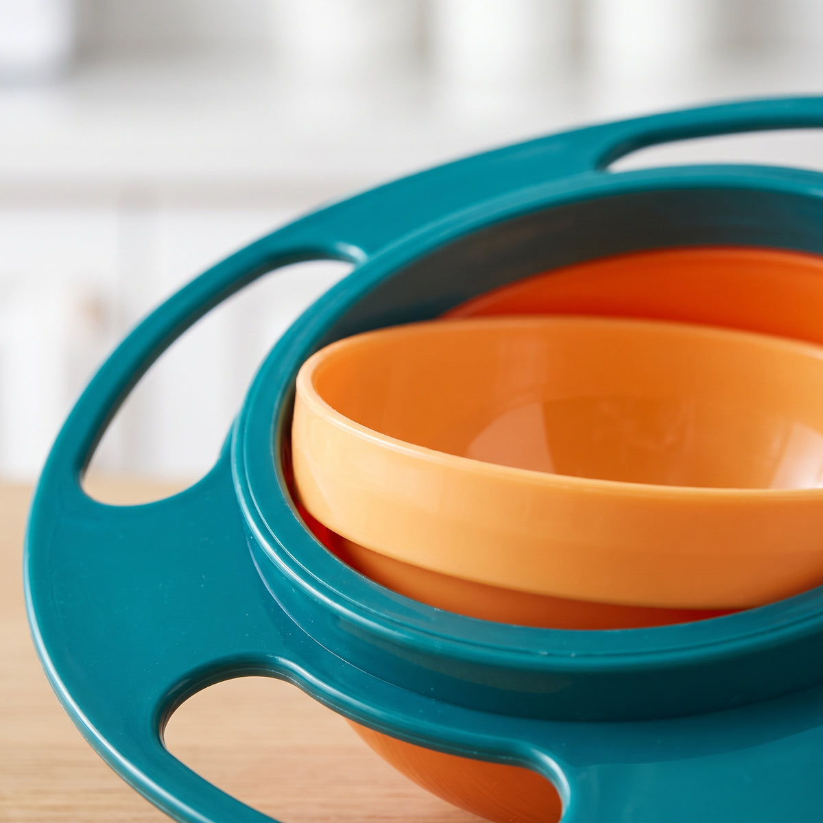 Close-up of the gyro bowl inner bowl nested in the teal ring and outer frame