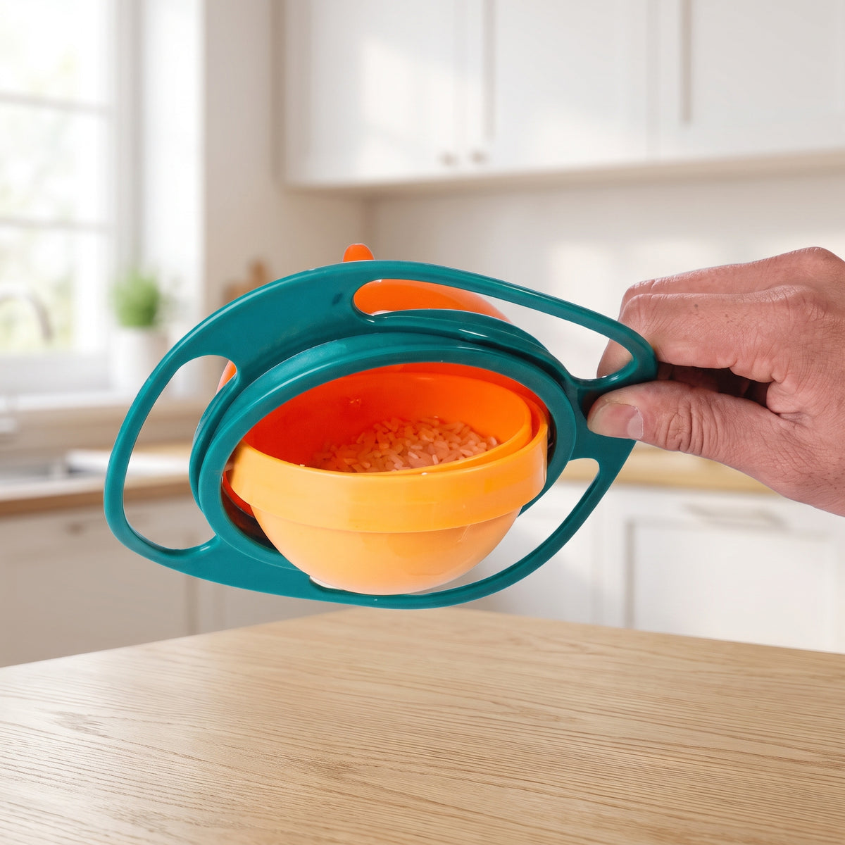 Hand tipping the gyro bowl outer frame while the inner bowl of rice stays level