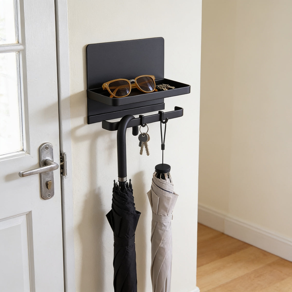 Black magnetic umbrella and key holder with tray on a front door