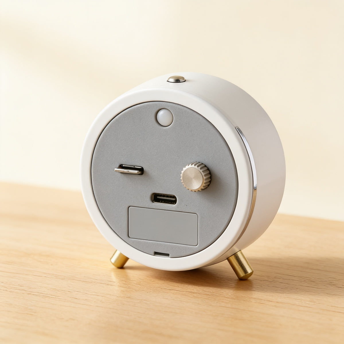 Back of the silent analog alarm clock showing the night-light button and battery door