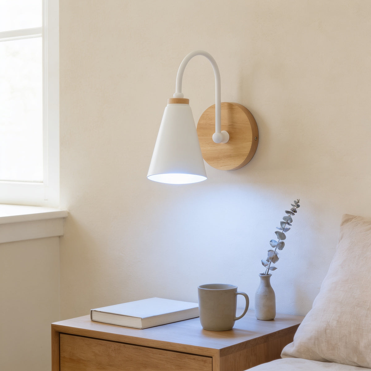 White cone wall sconce lit cool white above an oak nightstand — Nordic Wood & Metal Cone Wall Sconce