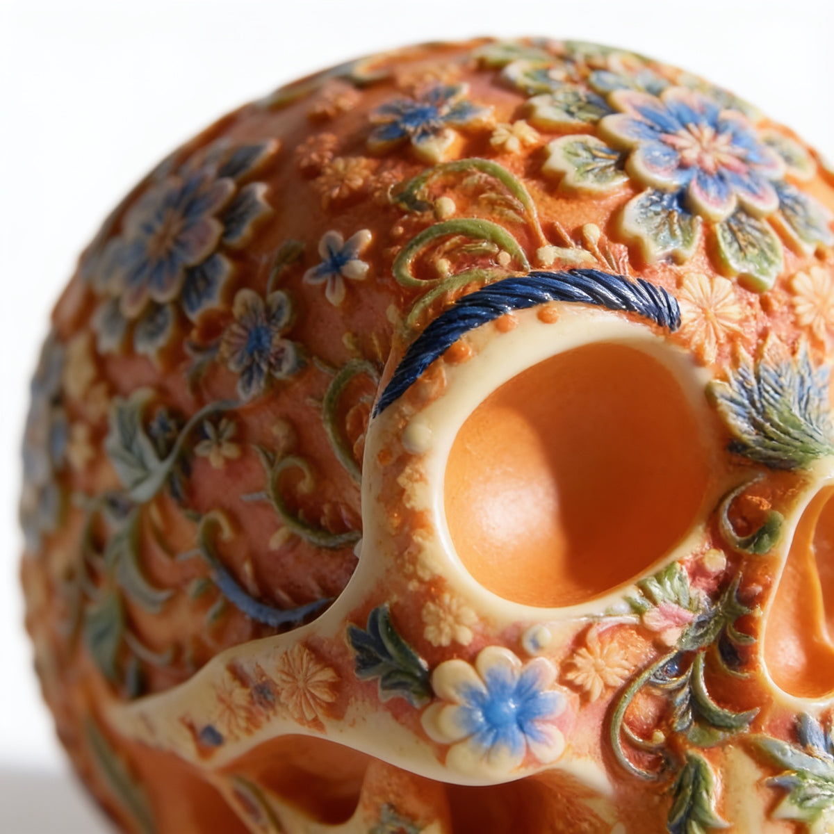 Close-up of the hand-painted floral pattern on the sugar skull figurine