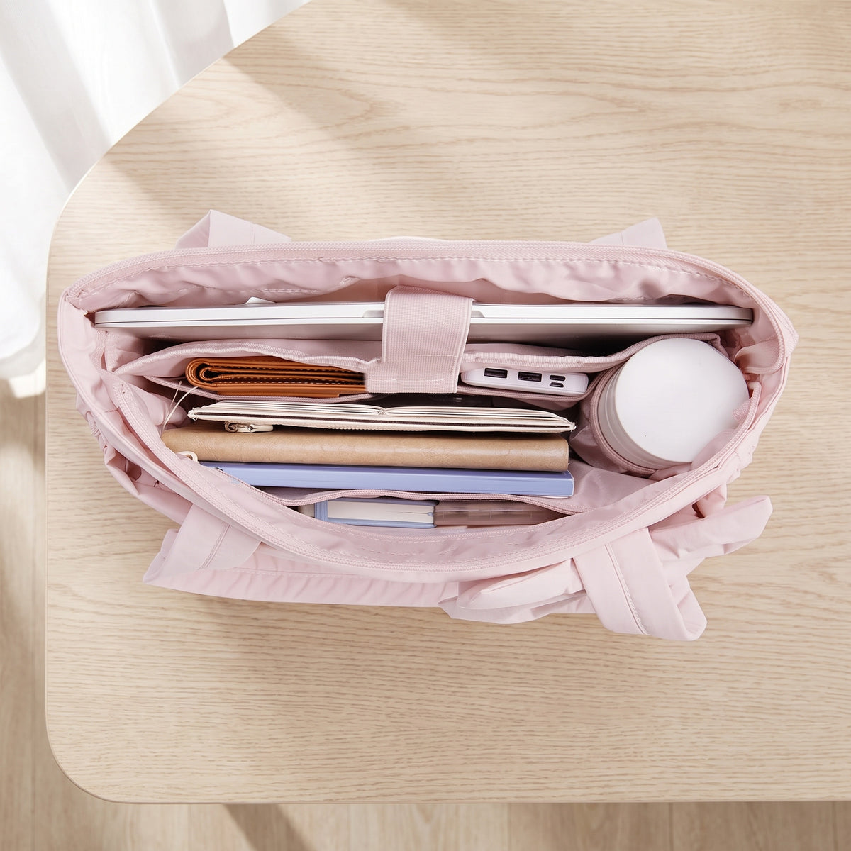 Inside the puffer tote: laptop slot with elastic tab, slide pockets and zip pocket (items not included)