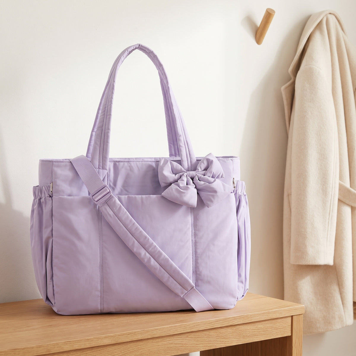 Lavender 15.6in puffer tote bag with its shoulder strap on an entryway bench