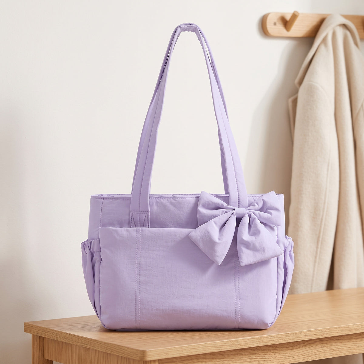 Lavender puffer laptop tote bag with a bow on an entryway bench