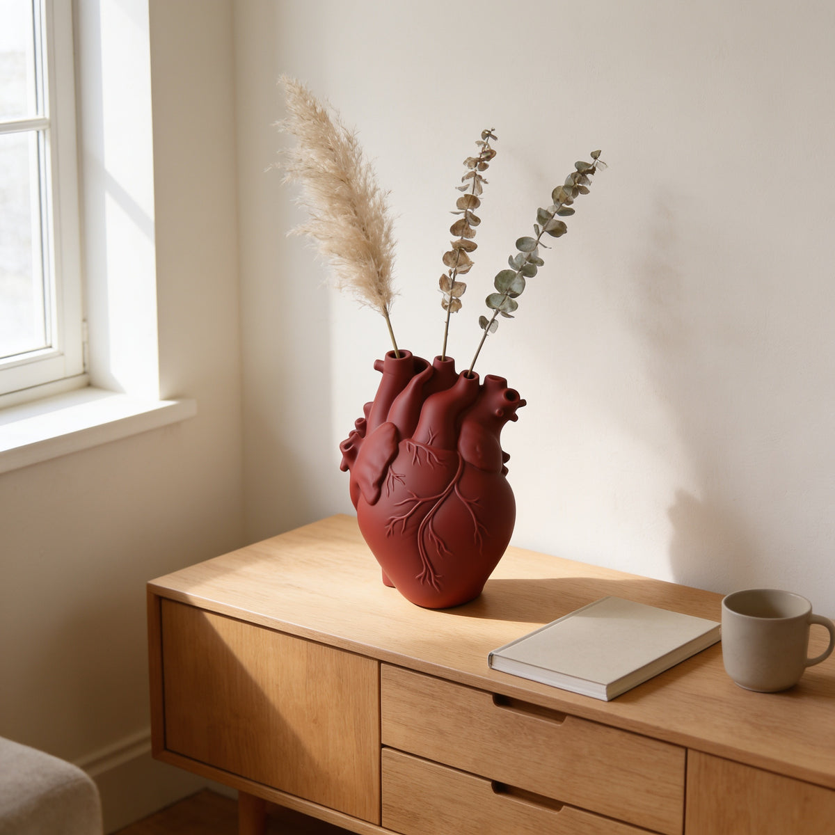 Red resin anatomical heart vase with dried stems on an oak console — Resin Anatomical Heart Vase