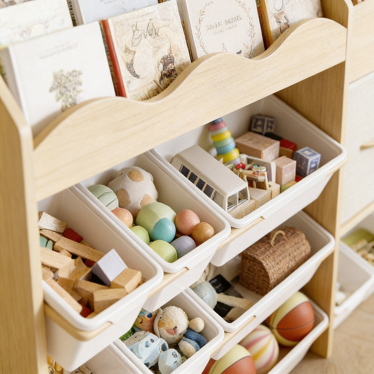 Close detail of the wavy book display shelf above the forward-tilted white toy bins.