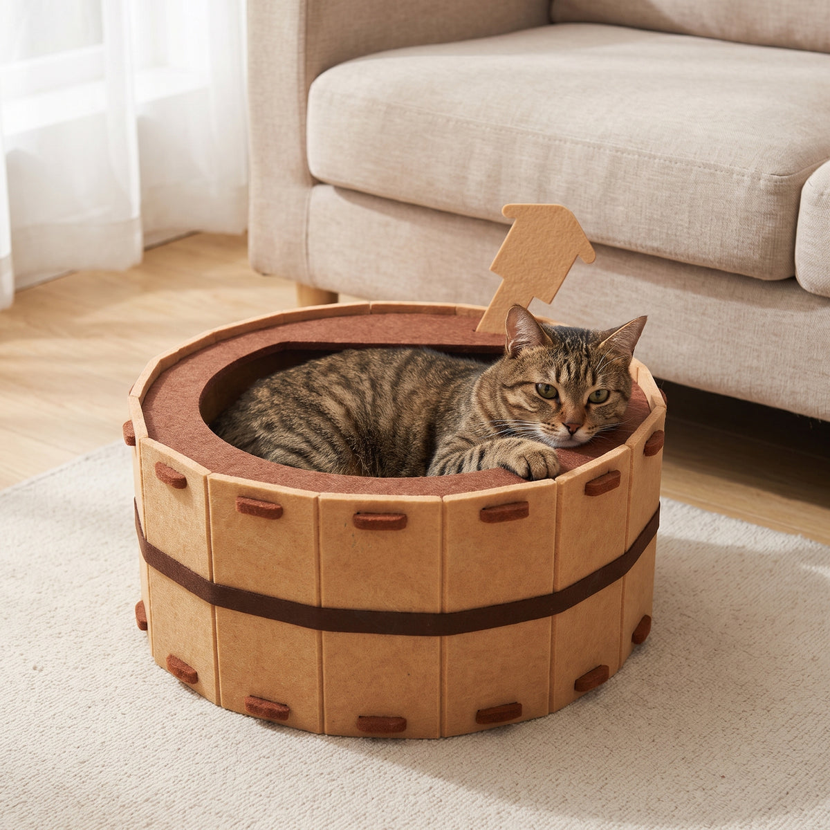 Brown tabby cat resting inside the felt tub-shaped cat bed in a living room
