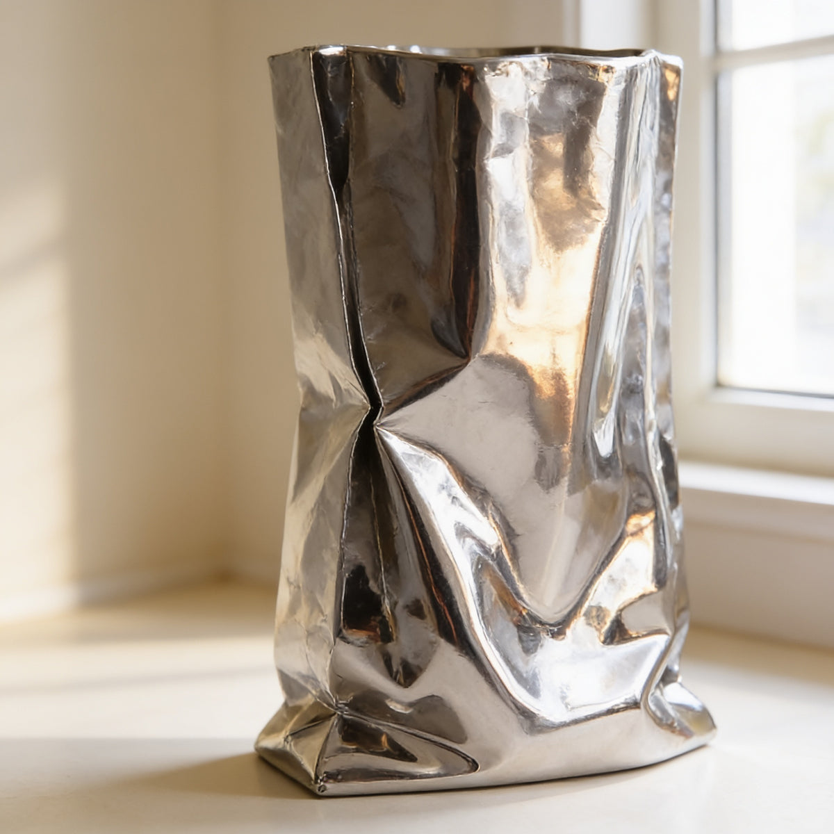 Close-up of the mirror-polished creases reflecting the room — Silver Crinkle Paper-Bag Vase
