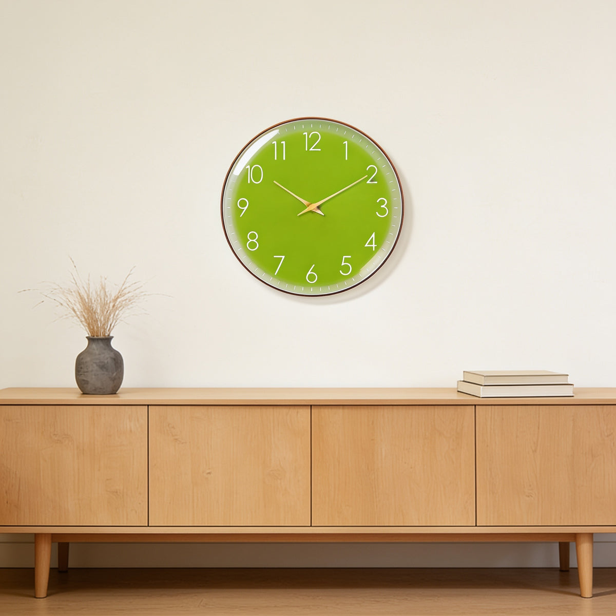 Apple green wall clock with a slim gold frame above an oak sideboard