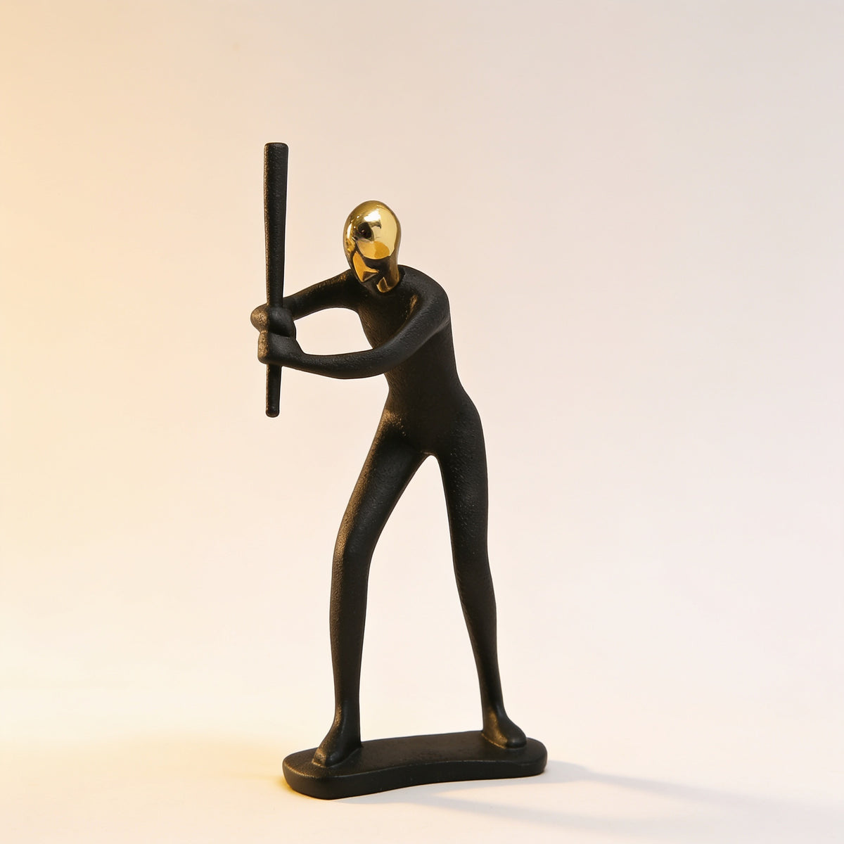 Baseball batter pose, black and gold resin figurine on cream background — Black & Gold Sports Figurine