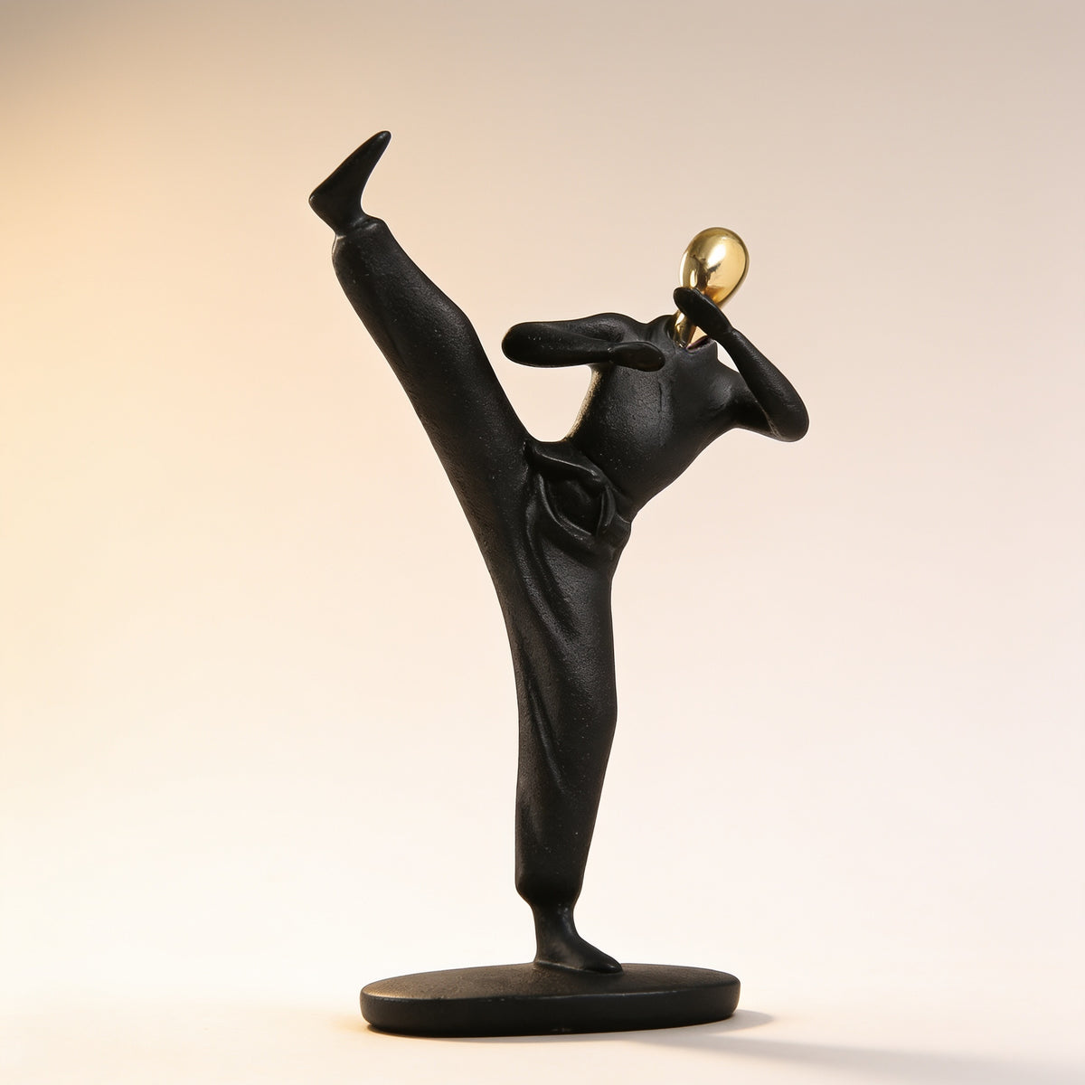 Karate kick pose, black and gold resin figurine on cream background — Black & Gold Sports Figurine