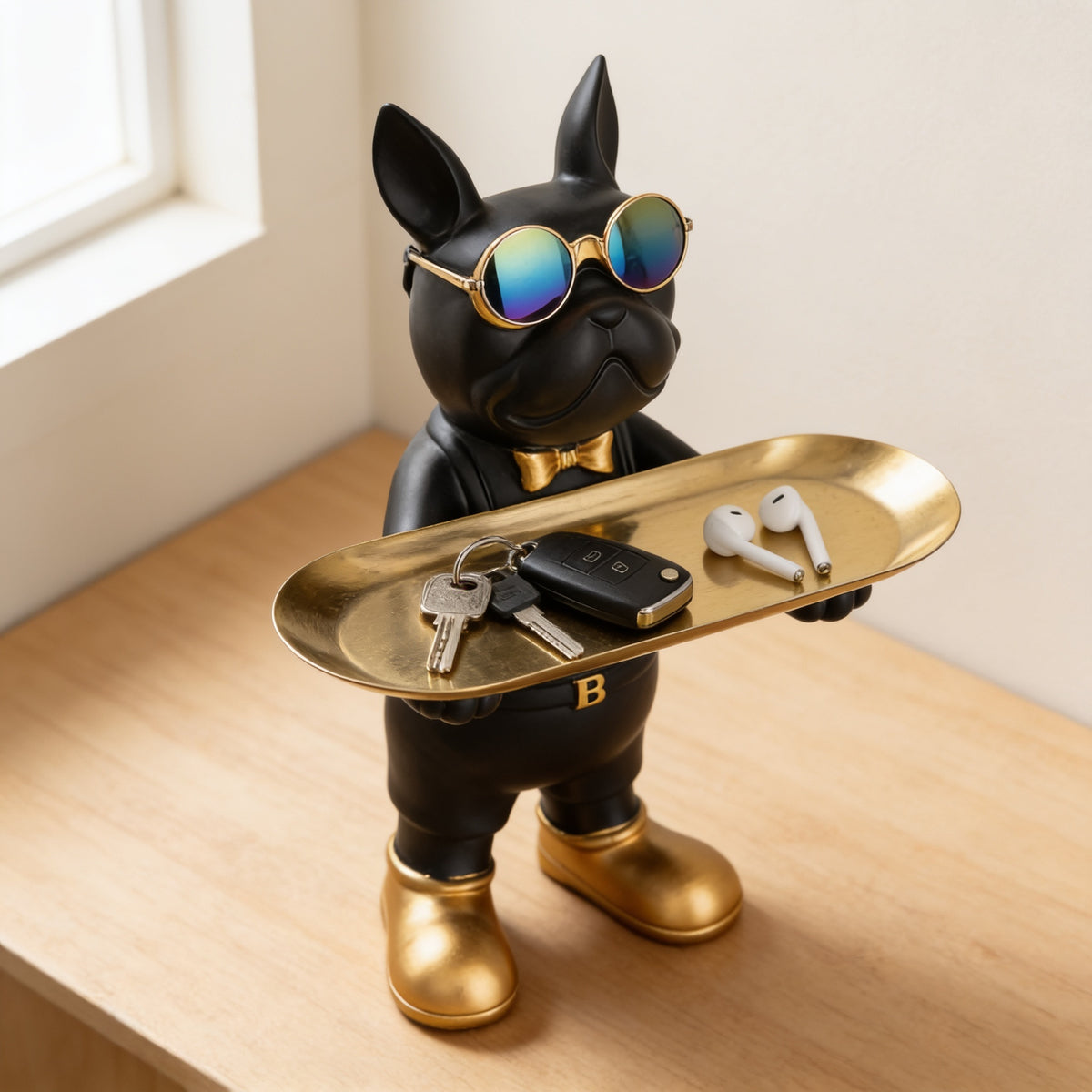 Bulldog butler statue tray holding keys and earbuds