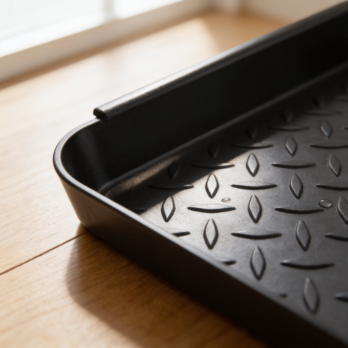 Close-up of the raised lip and textured surface of the boot tray