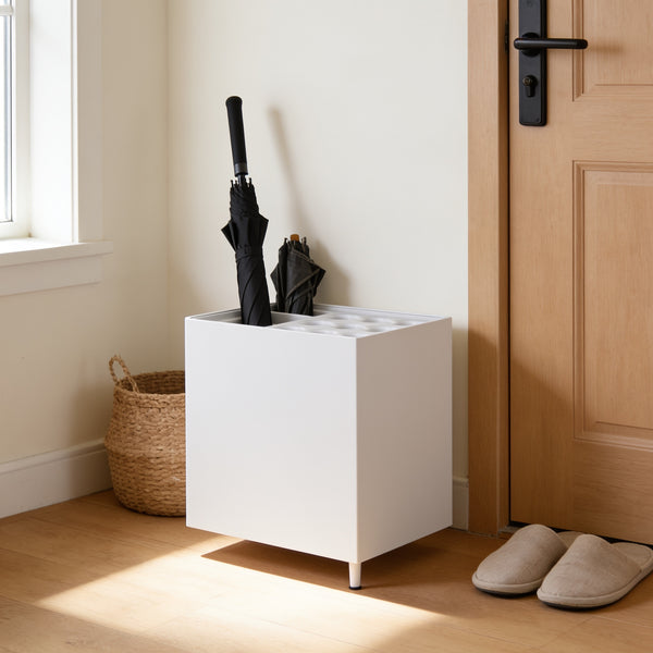 White nine-slot umbrella stand with drip tray by a front door