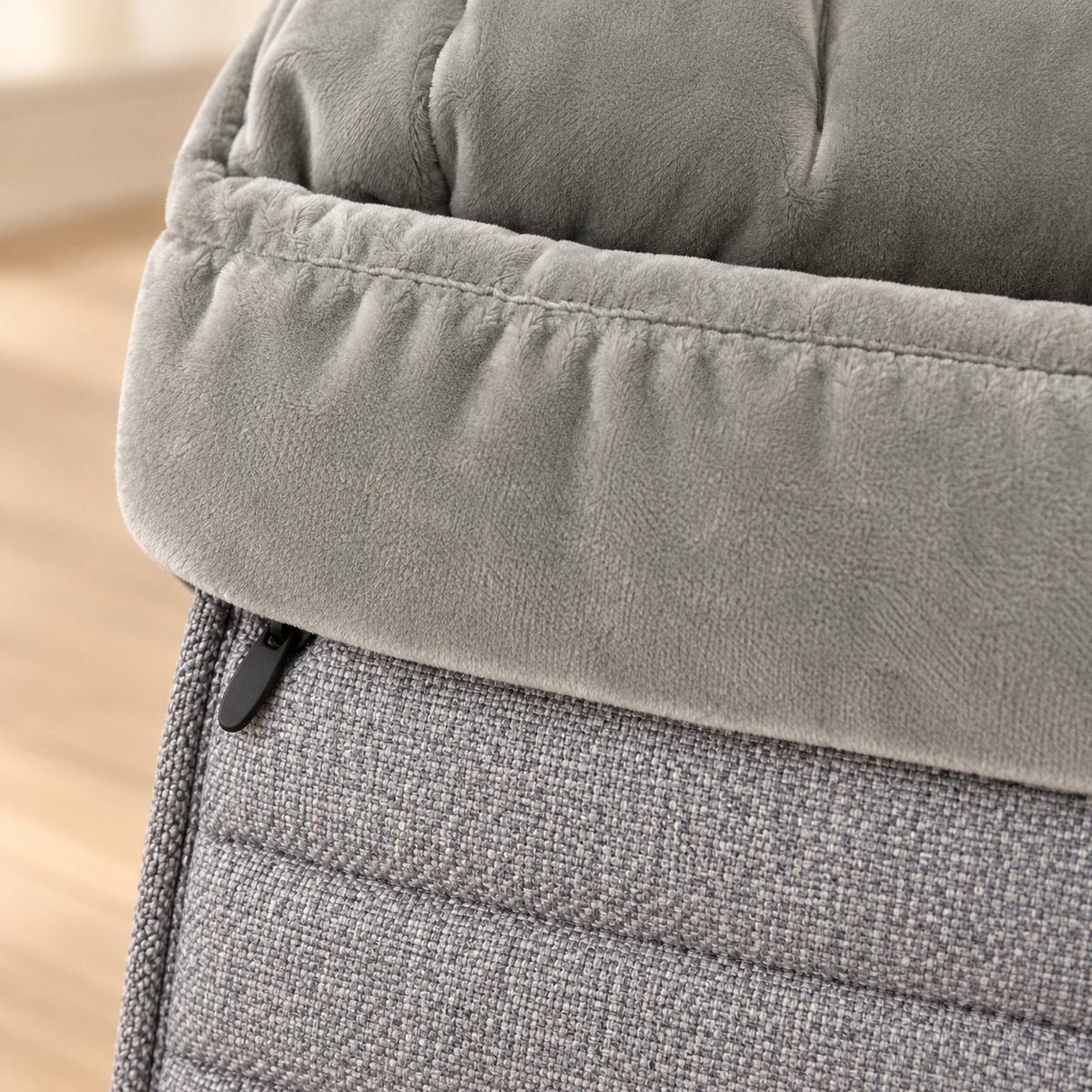 Close-up of the gray footmuff's velvet cuff, heathered outer fabric and side zipper