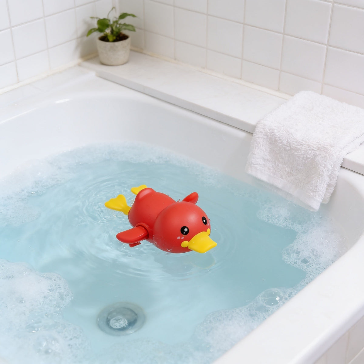 Wind-Up Duck, Red toddler bath toy in a bright bathtub.
