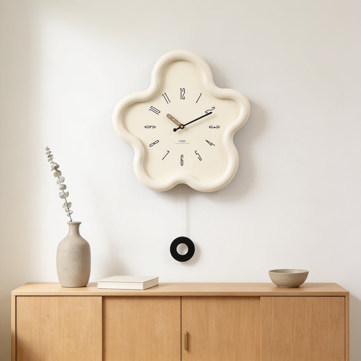 Cream white flower-shaped wall clock with swing pendulum above an oak sideboard — Wavy Flower-Shaped Wall Clock
