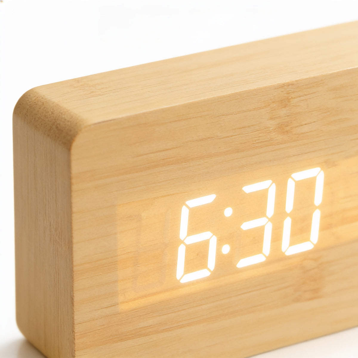 Close-up of the white LED digits glowing through the bamboo grain