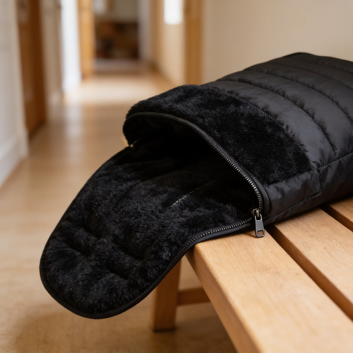 Black bunting bag unzipped to show its thick plush fleece lining.