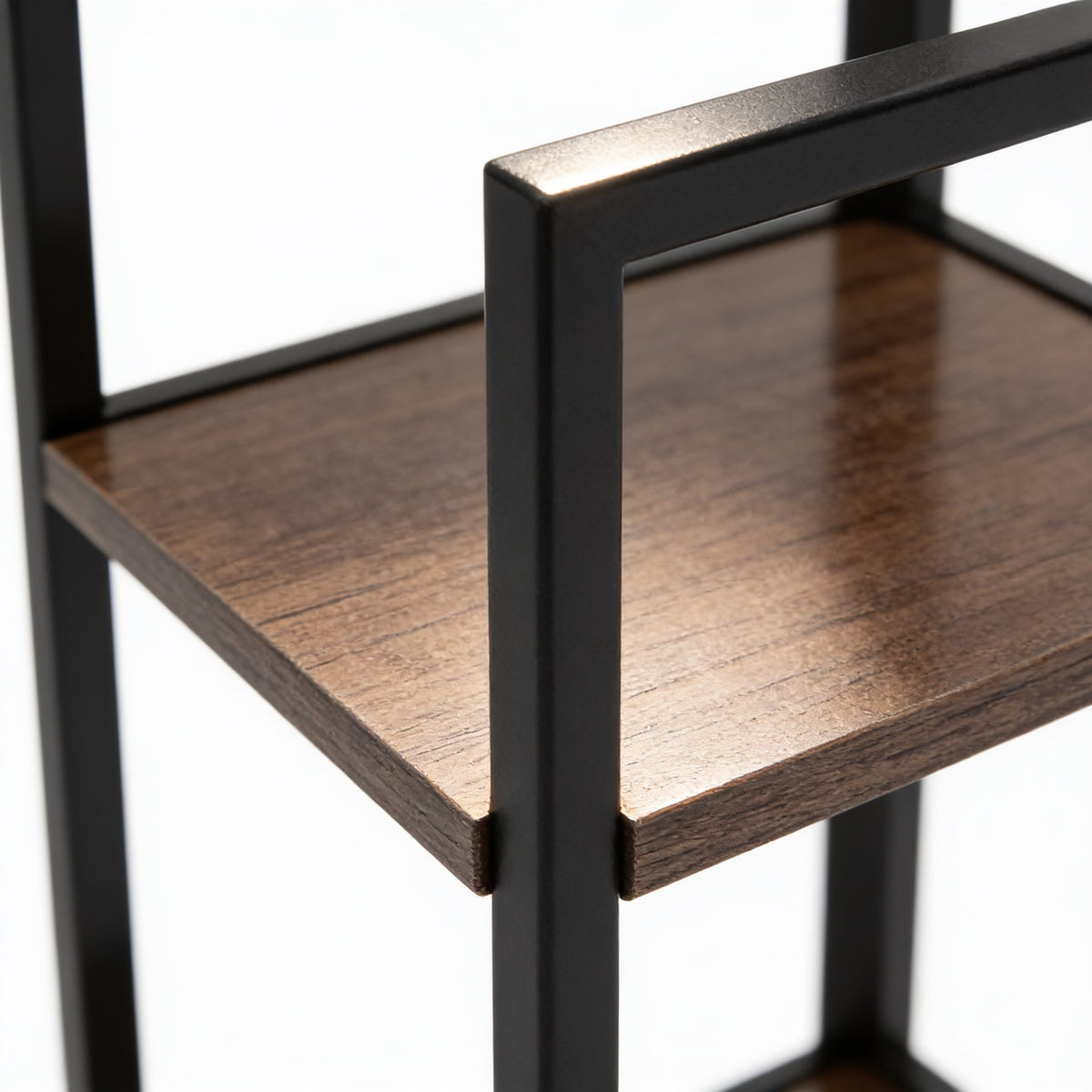 Close detail of the rustic brown wood shelf meeting the matte black steel frame at the corner of the rack.