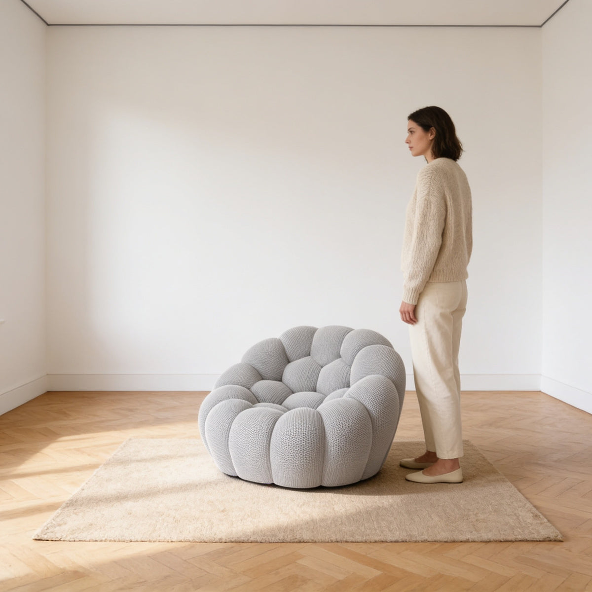 Adult standing beside the bubble armchair, whose back reaches only to the top of her thigh at seventy centimetres.