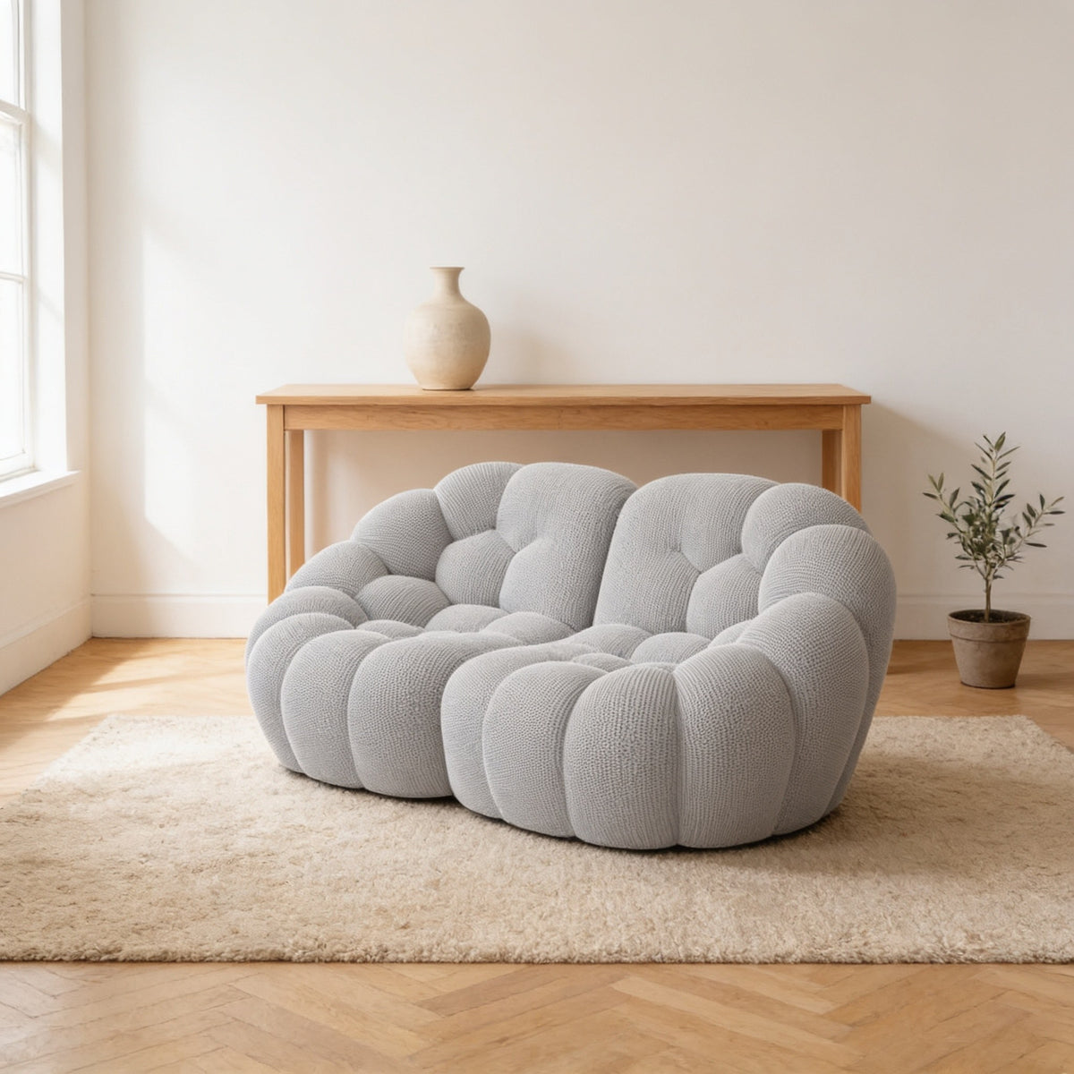 Light grey two-seat bubble sofa, two hundred centimetres wide, on an oatmeal rug in a warm living room.