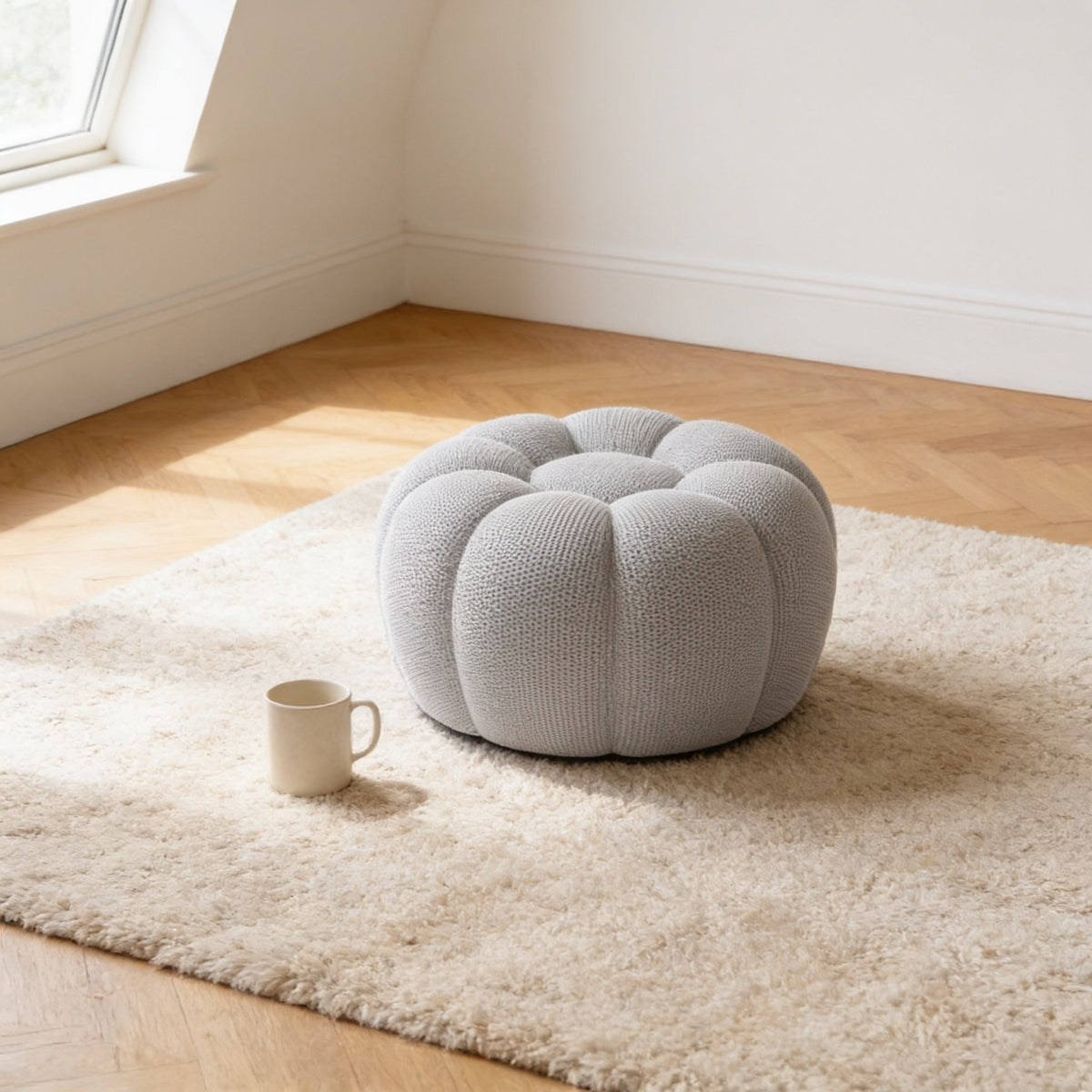 Round light grey bubble footstool, eighty centimetres across and thirty-six centimetres high, beside a mug for scale.