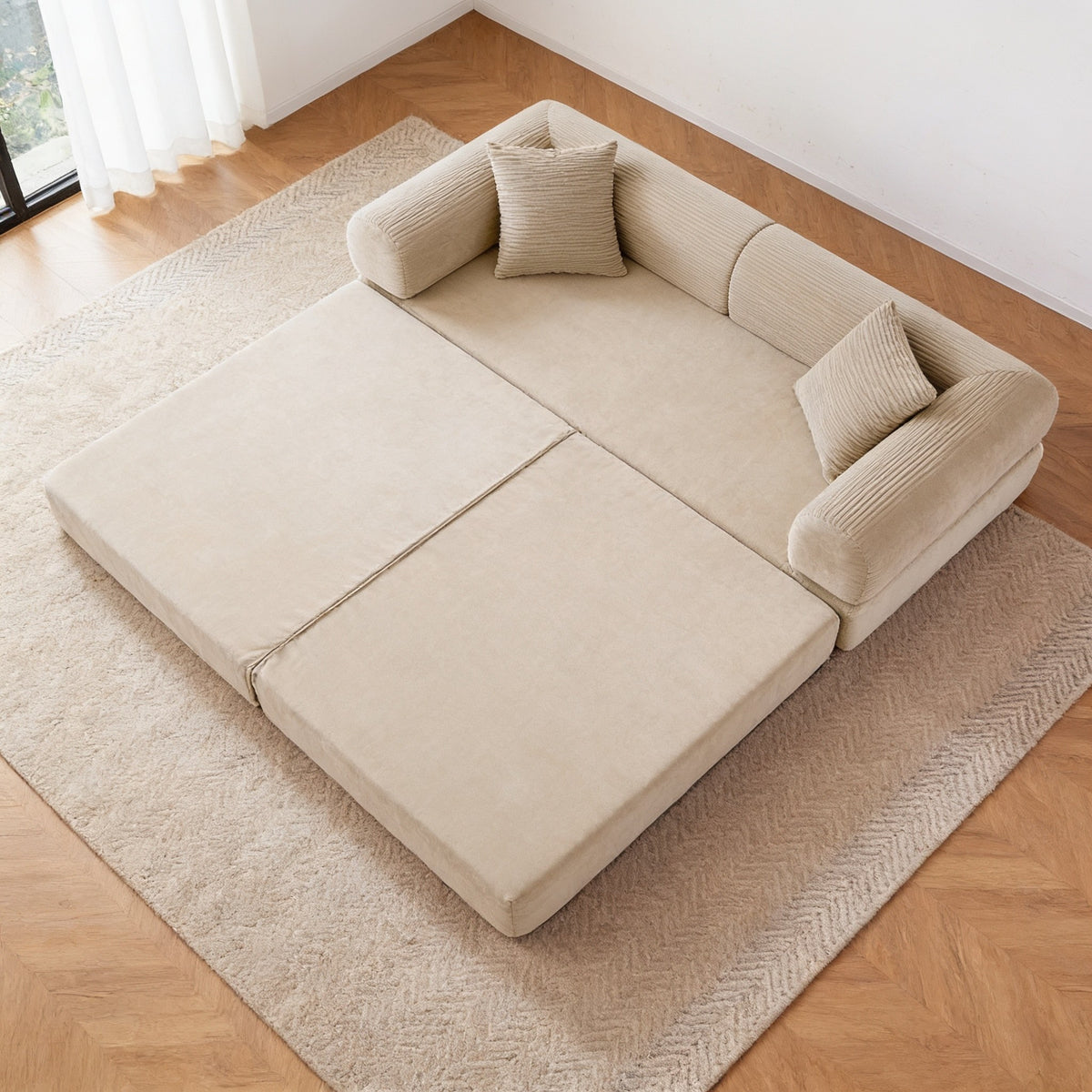 Beige corduroy folding sofa bed opened flat into bed mode, forming a near-square two hundred by one hundred and eighty centimetre mattress.