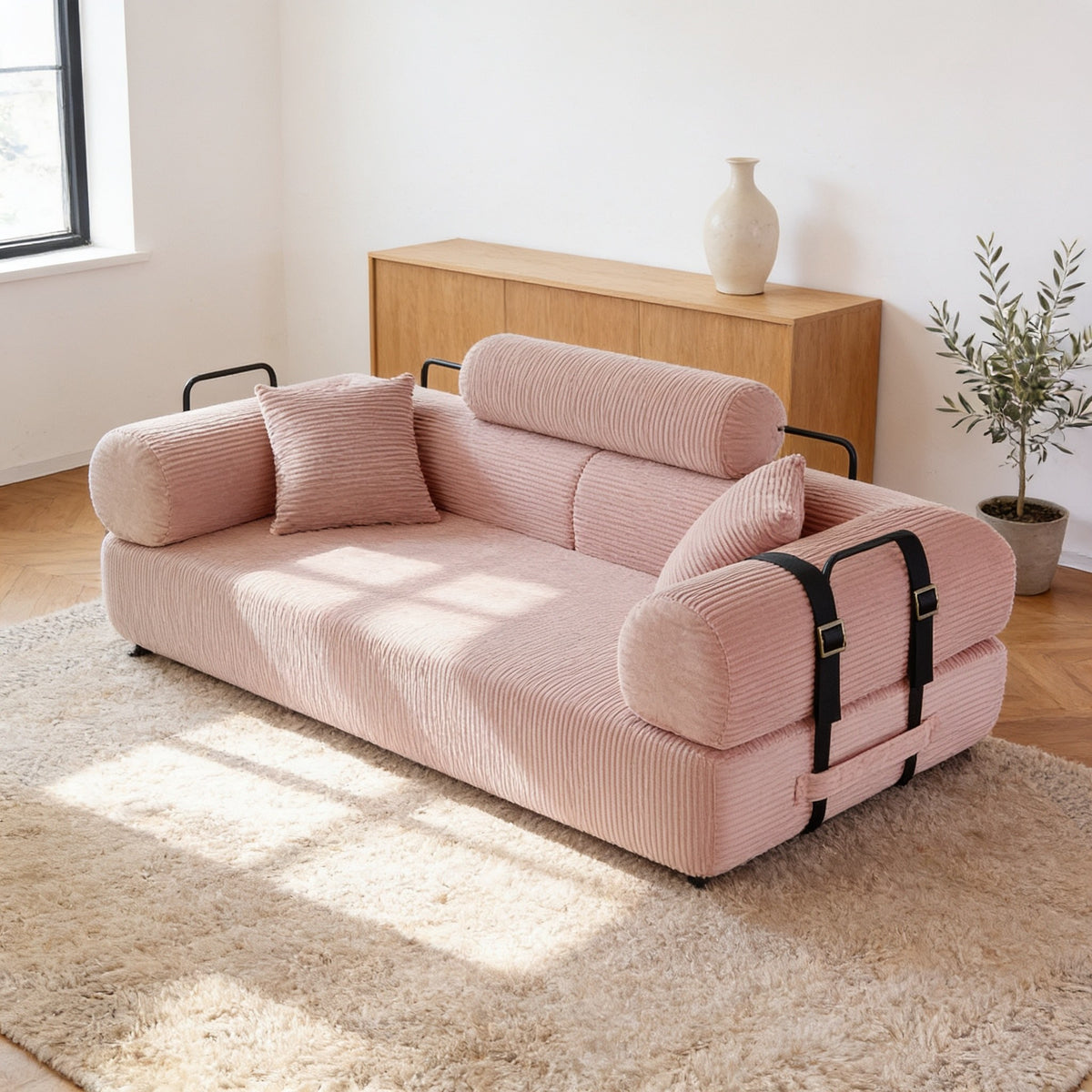 Blush pink corduroy folding sofa bed in sofa mode, seventy-nine inch size.
