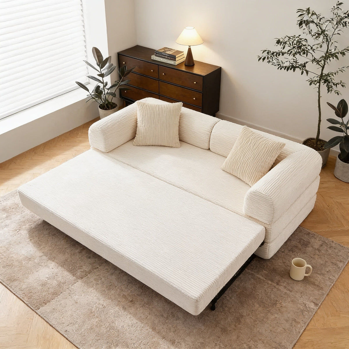 Beige corduroy sofa bed part-opened into lounger mode, the foam seat layer extended forward across the rug.