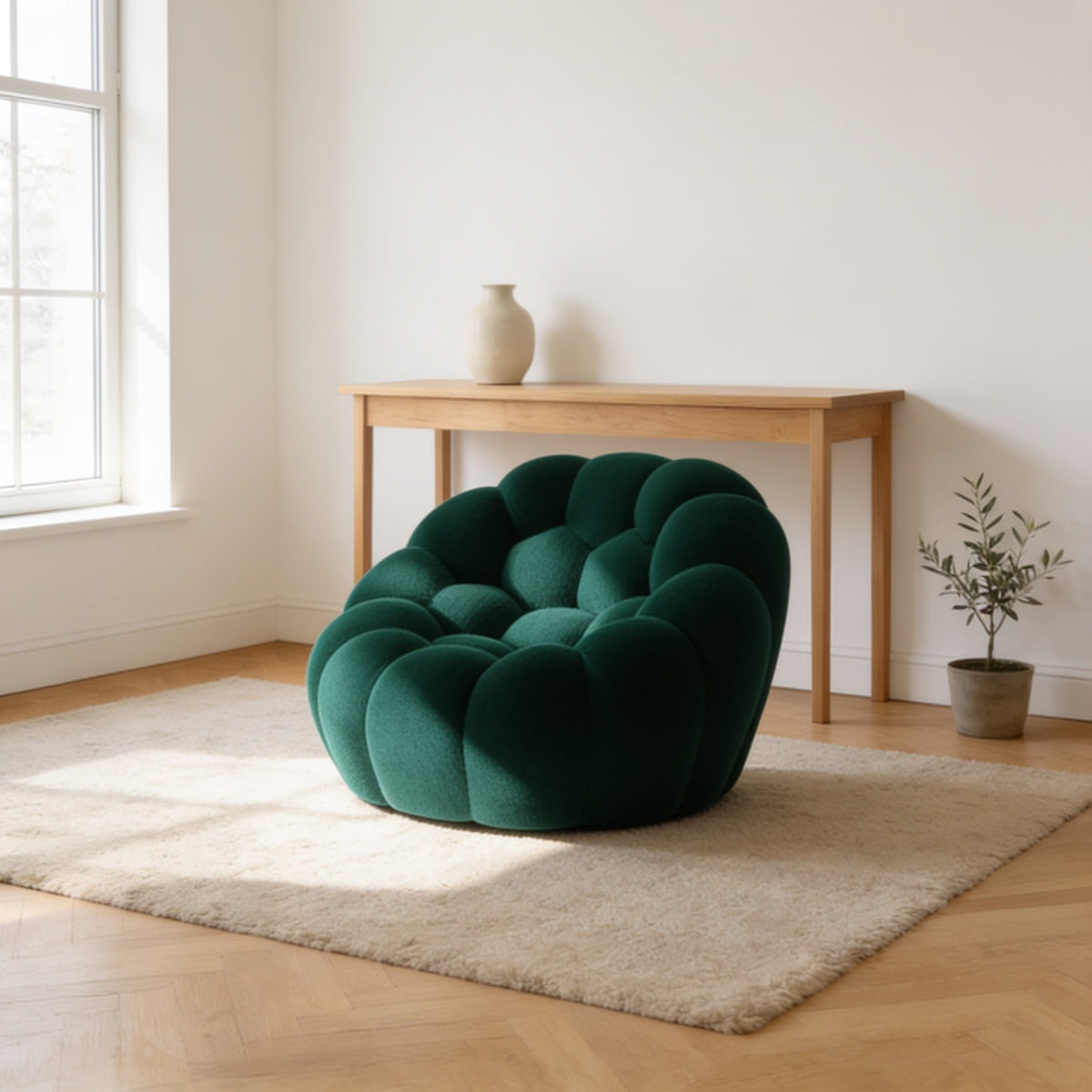 Forest green bubble armchair in a three-dimensional mesh knit, one hundred and twenty-four centimetres wide.