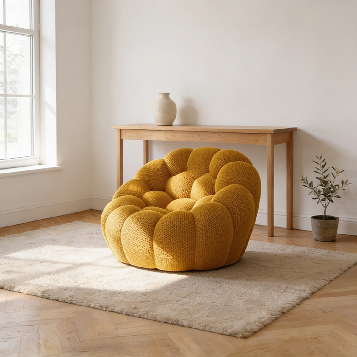 Golden yellow bubble armchair in a three-dimensional mesh knit, one hundred and twenty-four centimetres wide.